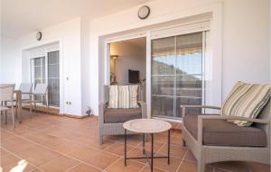 a living room with chairs and a table at Stunning Apartment In Rincn De La Victoria With Kitchen in Rincón de la Victoria