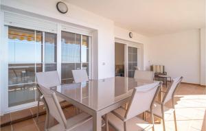 a dining room with a glass table and chairs at Stunning Apartment In Rincn De La Victoria With Kitchen in Rincón de la Victoria