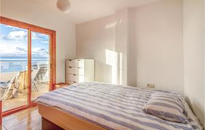 a bedroom with a bed and a view of the ocean at 3 Bedroom Cozy Apartment In Santa Pola in Santa Pola