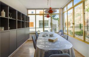 a dining room with a table and some windows at 3 Bedroom Cozy Apartment In Santa Pola in Santa Pola