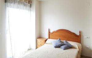 a bedroom with a bed with two pillows on it at Cozy Apartment In Oropesa Del Mar in Oropesa del Mar