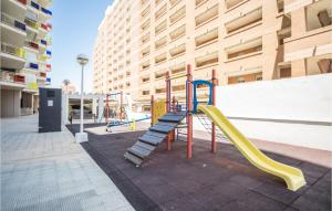 a playground with a yellow slide and a slideintend at Cozy Apartment In Oropesa Del Mar in Oropesa del Mar