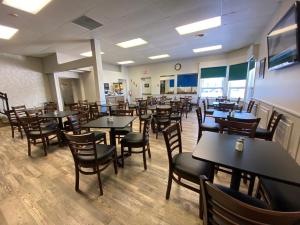 a dining room filled with tables and chairs at Days Inn by Wyndham Brockville in Brockville