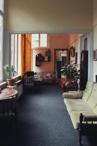 a living room with a couch and a table at At Funicular Hostel in Tbilisi City