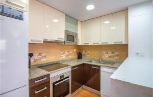 a kitchen with white cabinets and a sink at Cozy Apartment In Torrevieja With Wifi in Torrevieja