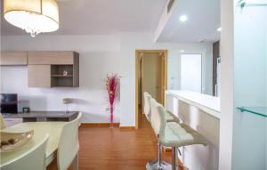 a kitchen and dining room with a table and chairs at Cozy Apartment In Torrevieja With Wifi in Torrevieja