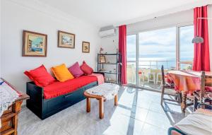 a living room with a red couch and a balcony at Amazing Apartment In Torremolinos in Torremolinos