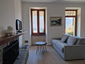 a living room with a couch and a tv at BorgoCastello in Rezzonico