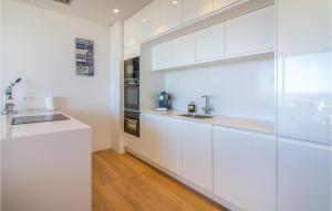 eine weiße Küche mit weißen Schränken und einer Spüle in der Unterkunft Stunning Apartment In Orihuela in Orihuela