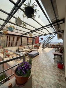 a patio with a glass roof with plants and flowers at calmsutra in Kathmandu