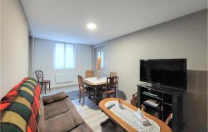 sala de estar con sofá, TV y mesa en Nice Home In Les Premiers-sapins With Ethernet Internet, en Athose