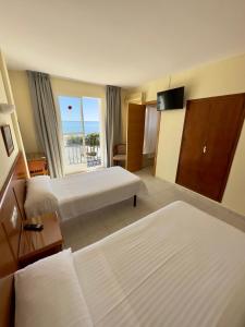 Postel nebo postele na pokoji v ubytování Hotel Cabello