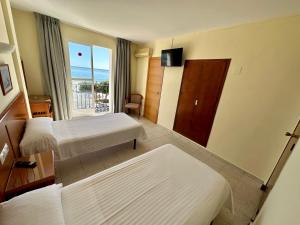 Postel nebo postele na pokoji v ubytování Hotel Cabello