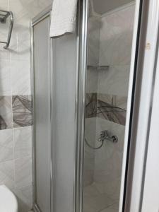 a shower with a glass door in a bathroom at Hotel Ay in Istanbul