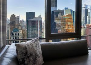 a couch in front of a window with a city view at New York Marriott Marquis in New York