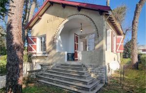 a small house with a stairway leading to a door at Lovely Home In Meschers-Sur-Gironde in Meschers-sur-Gironde