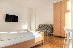 a hotel room with two beds and a chair at Comfortable 3BR shared Apart. - Suitable For Long Stays in Vienna