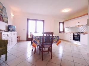a kitchen with a table and chairs in it at Palau Sea View apartment in Palau
