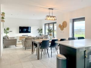 a kitchen and living room with a table and chairs at Park View in Kingsley