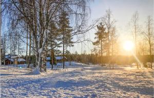 a snow covered field with the sun in the background at Amazing Apartment In Mesnali With Ethernet Internet in Mesnali