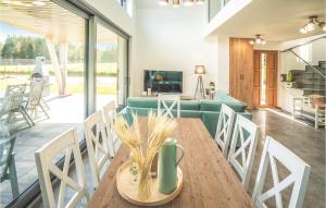 a dining room and living room with a table and chairs at Stunning Home In Ryn With Wifi in Ryn