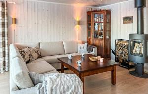 a living room with a couch and a coffee table at Beautiful Home In Noresund With Wifi in Noresund
