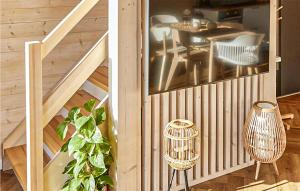 two pictures of a house with a staircase and a table at Cozy Home In Trzesacz With Kitchen in Trzęsacz