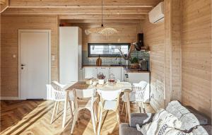 a kitchen and dining room with a table and chairs at Cozy Home In Trzesacz With Kitchen in Trzęsacz