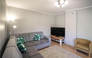 a living room with a couch and a flat screen tv at Gorgeous Home In Ryn With Wifi in Ryn