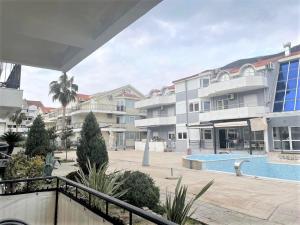a view of a large apartment complex with a swimming pool at 50m-to-Sea Holiday Apartment Norwegian Village in Đenovići