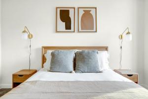 a bedroom with a bed with two lamps and two pillows at Bethesda 1BR w Concierge Gym WD nr Metro WDC-332 in Bethesda +34 photos