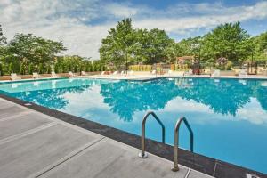 a swimming pool at a resort with blue water at Clarendon 1BR w Gym WD Doorman nr Metro WDC-350 in Arlington