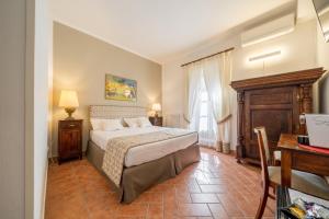Schlafzimmer mit einem Bett und einem Schreibtisch mit einem Laptop in der Unterkunft Affittacamere Valentina in Orvieto