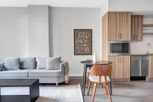 a living room with a couch and a table at Clarendon 1BR w Gym WD Pool nr Metro WDC-381 in Arlington