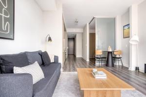 a living room with a gray couch and a coffee table at Bethesda 1BR w Gym WD Lounge nr Metro WDC-538 in Bethesda +16 photos