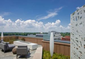 a patio with chairs and a table on a roof at Bethesda 1BR w Gym WD Lounge nr Metro WDC-538 in Bethesda