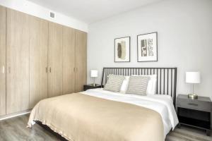 a white bedroom with a large bed and two lamps at Bethesda 1BR w Gym WD Lounge nr Metro WDC-538 in Bethesda
