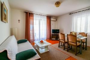 a living room with a couch and a table at Apartments Katarina k in Malinska