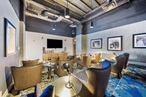 a waiting room with chairs and a flat screen tv at Heart of Downtown with Amazing Amenities steps from Nightlife 503 in Cincinnati