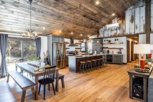 an open kitchen and dining room with a wooden ceiling at New Rustic Luxe Cabin Billiards Spa Near GSMNP in Townsend