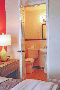 a bathroom with a toilet and a sink at La Posada in Milford +35 photos