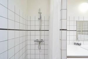 a bathroom with a shower and a sink at Large & Stylish Apartments in Trendy & Vibrant Neighbourhood in Copenhagen +30 photos