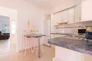 a kitchen with white cabinets and a counter top at Villa Mar Deluxe in Castillo del Romeral