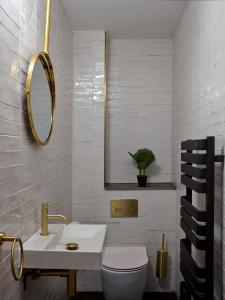 a bathroom with a sink and a toilet and a mirror at Ainster House in Fife +33 photos