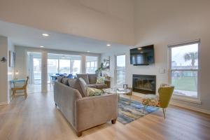 a living room with a couch and a fireplace at Luxury Galveston Retreat - Walk to Pirates Beach! in Galveston