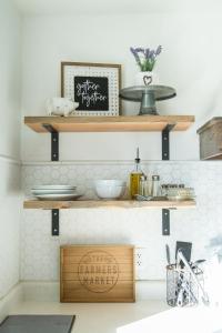 a kitchen with wooden shelves on the wall at Happy Trails BnB in Tropic