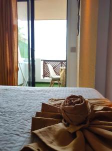 a bedroom with a bed with a towel on it at Golf del Sur Albatros Park Piscina Climatizada fast wifi in San Miguel de Abona