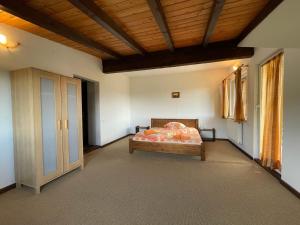 a bedroom with a bed and a wooden ceiling at Pensiunea Cehov in Bran