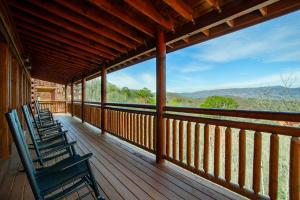 three chairs on a porch with a view of the mountains at Pool and Game Room in Stunning Mountain Cabin in Pigeon Forge