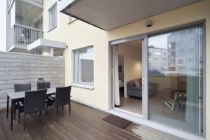 a dining room with a table and chairs in a house at Norden Homes Castle Harbour Apartment in Turku